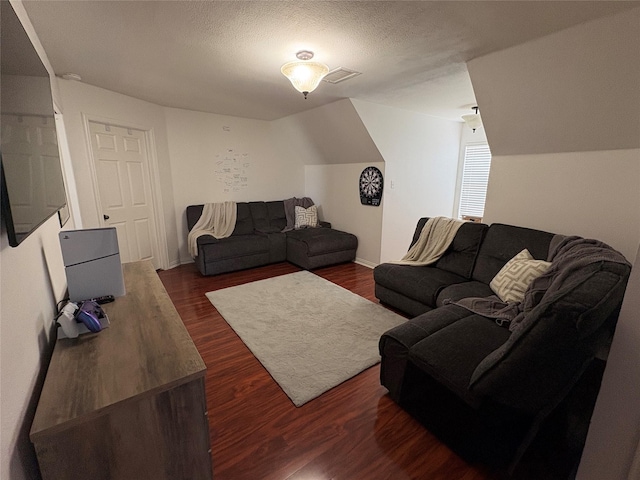 702 John Thomas Dr, Keene, TX 76059 - living room featuring dark wood-type flooring and a textured ceiling