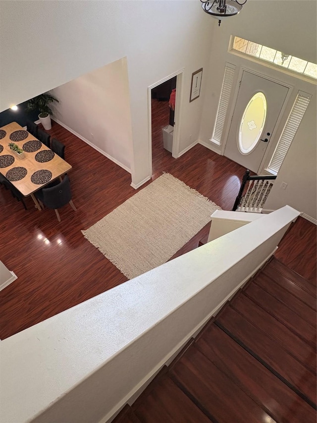 702 John Thomas Dr, Keene, TX 76059 - foyer featuring baseboards, wood finished floors, a high ceiling, and a chandelier