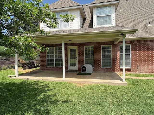 702 John Thomas Dr, Keene, TX 76059 - back of property featuring roof with shingles, a patio, a yard, and brick siding