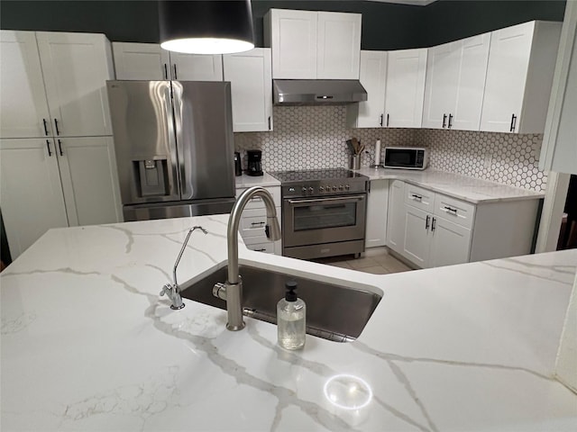 702 John Thomas Dr, Keene, TX 76059 - kitchen with appliances with stainless steel finishes, extractor fan, white cabinets, backsplash, and a sink