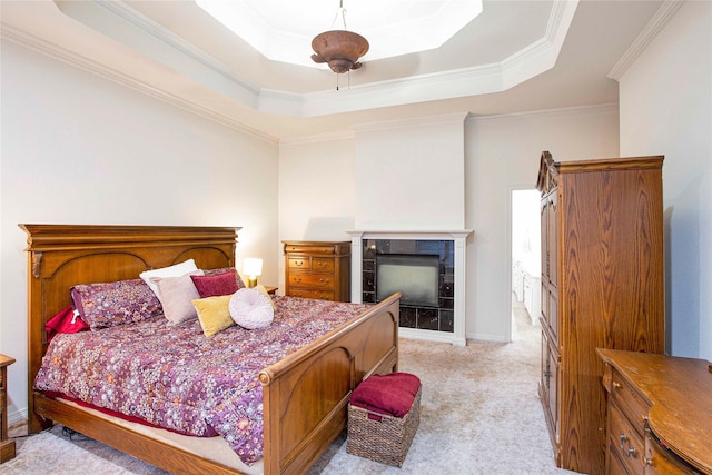 1991 Saint Andrews Dr, Red Oak, TX 75154 - bedroom featuring a tray ceiling, a tiled fireplace, light carpet, and ornamental molding