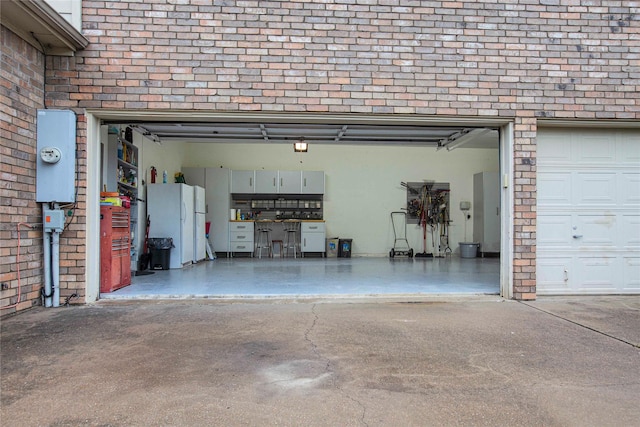 1991 Saint Andrews Dr, Red Oak, TX 75154 - garage featuring freestanding refrigerator and driveway