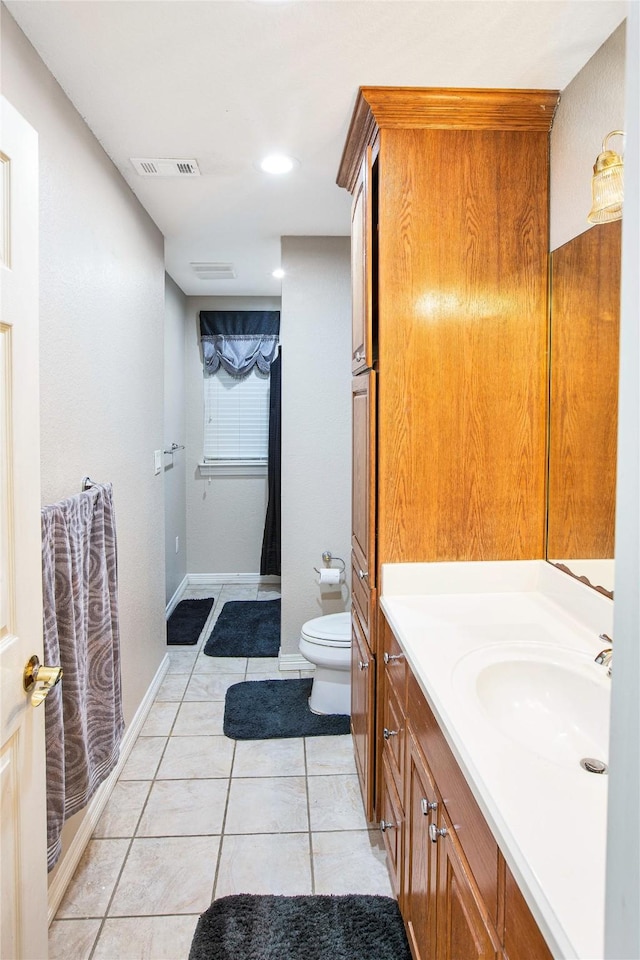 1991 Saint Andrews Dr, Red Oak, TX 75154 - bathroom with vanity, toilet, tile patterned floors, baseboards, and recessed lighting