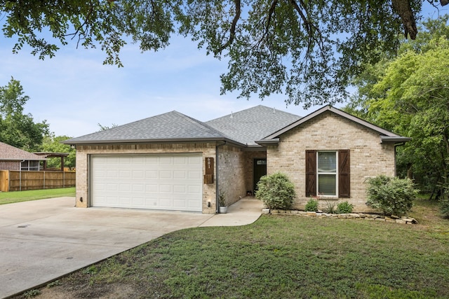 601 S 4th St, Crandall, TX 75114 - view of front of property with driveway, roof with shingles, an attached garage, and brick siding