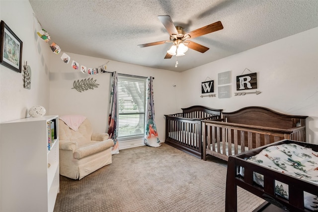 3410 Queenswood Ln, Garland, TX 75040 - bedroom featuring carpet flooring, a textured ceiling, a nursery area, and a ceiling fan