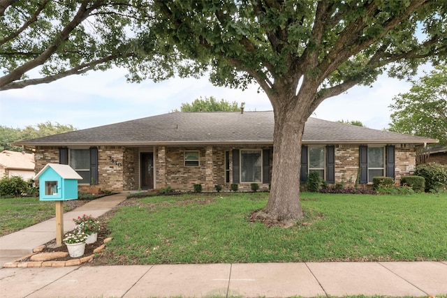 3410 Queenswood Ln, Garland, TX 75040 - ranch-style house with a front yard, brick siding, and a shingled roof