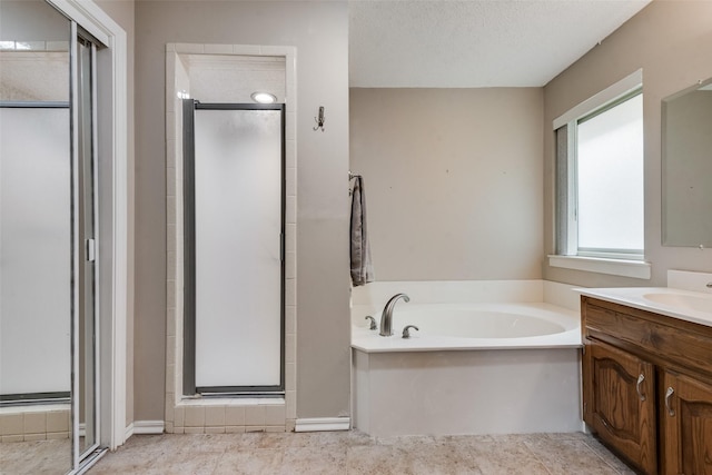 3410 Queenswood Ln, Garland, TX 75040 - full bathroom featuring vanity, a stall shower, a garden tub, a textured ceiling, and tile patterned flooring