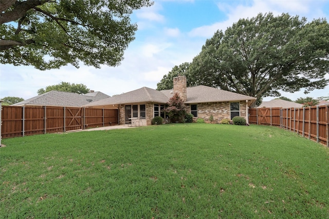3410 Queenswood Ln, Garland, TX 75040 - rear view of property with a chimney, brick siding, and a patio
