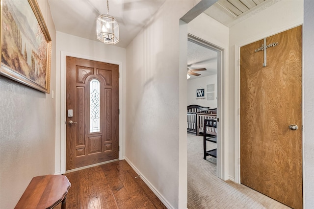 3410 Queenswood Ln, Garland, TX 75040 - entrance foyer featuring baseboards, hardwood / wood-style flooring, and a chandelier