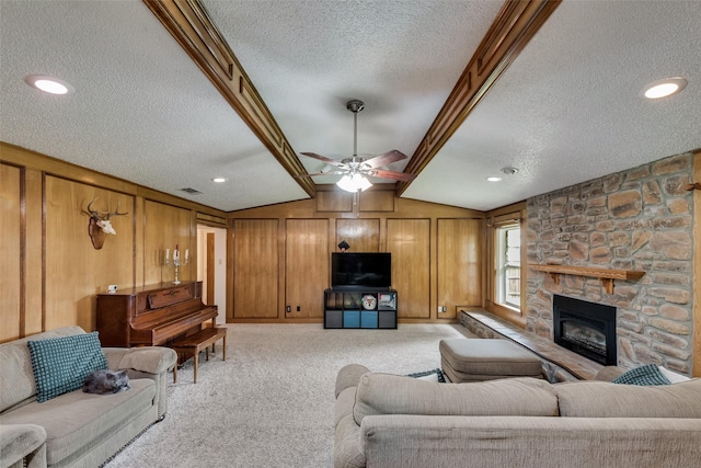 3410 Queenswood Ln, Garland, TX 75040 - living area featuring a textured ceiling, carpet floors, wooden walls, lofted ceiling, and a stone fireplace