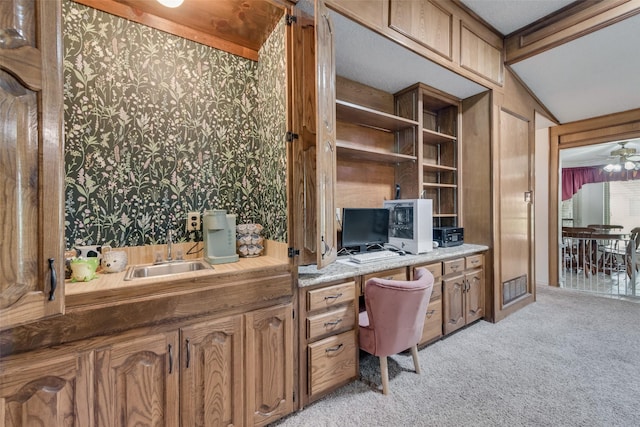3410 Queenswood Ln, Garland, TX 75040 - office area featuring built in study area, light colored carpet, ceiling fan, wallpapered walls, and a sink