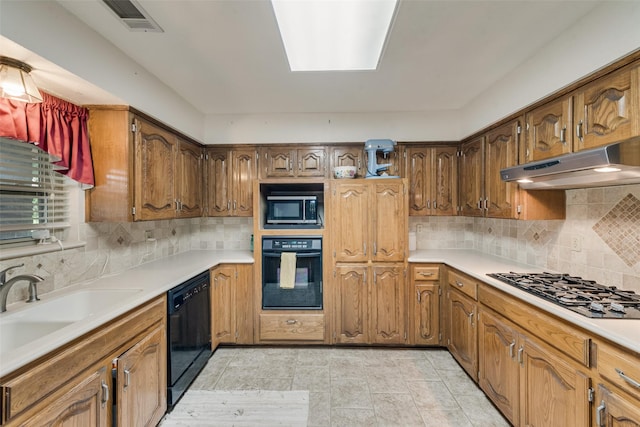 3410 Queenswood Ln, Garland, TX 75040 - kitchen with black appliances, under cabinet range hood, tasteful backsplash, light countertops, and a sink