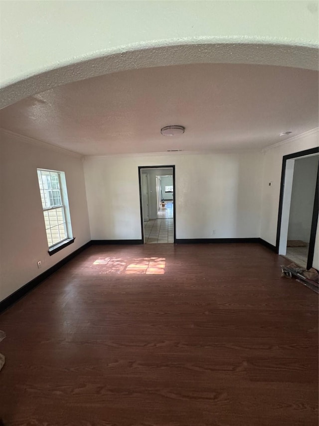 205 W Bond St, Denison, TX 75020 - unfurnished room featuring dark wood-type flooring, baseboards, and crown molding