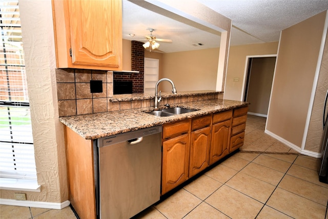 2906 Kingswood Dr, Garland, TX 75040 - kitchen featuring stainless steel dishwasher, a sink, light tile patterned floors, baseboards, and a textured ceiling