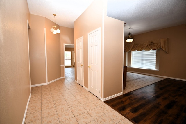 2906 Kingswood Dr, Garland, TX 75040 - hall featuring plenty of natural light, baseboards, a chandelier, and tile patterned flooring