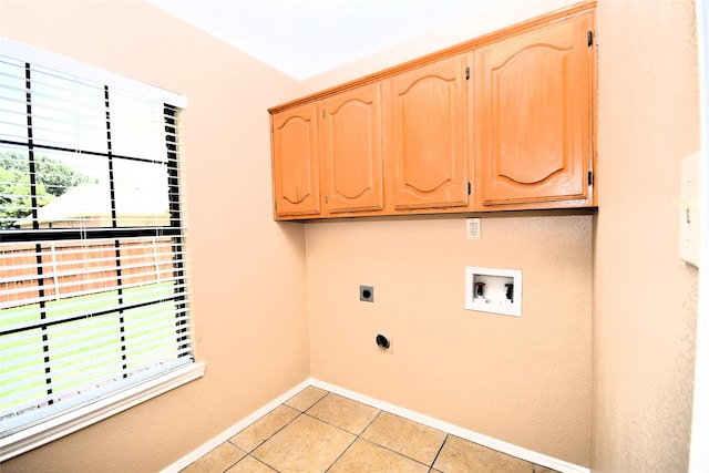 2906 Kingswood Dr, Garland, TX 75040 - laundry room with hookup for an electric dryer, cabinet space, plenty of natural light, and light tile patterned floors