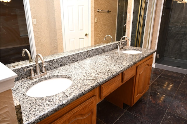 2906 Kingswood Dr, Garland, TX 75040 - full bathroom featuring double vanity, tile patterned floors, a stall shower, and a textured wall