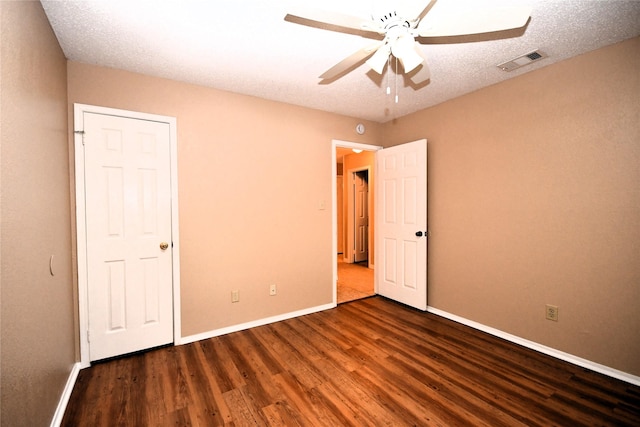 2906 Kingswood Dr, Garland, TX 75040 - unfurnished bedroom with wood finished floors, baseboards, and a ceiling fan