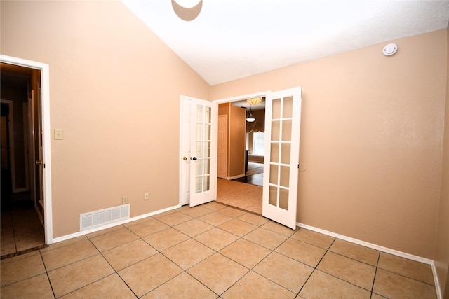 2906 Kingswood Dr, Garland, TX 75040 - unfurnished room featuring french doors, lofted ceiling, light tile patterned floors, baseboards, and a smoke detector