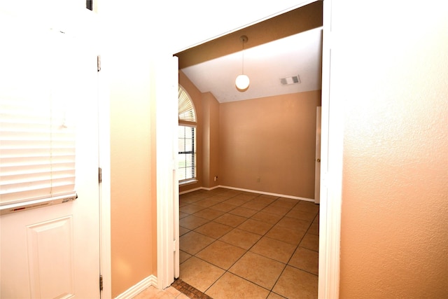 2906 Kingswood Dr, Garland, TX 75040 - empty room featuring light tile patterned floors, baseboards, and vaulted ceiling