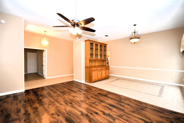 2906 Kingswood Dr, Garland, TX 75040 - unfurnished living room with a ceiling fan, baseboards, and wood finished floors