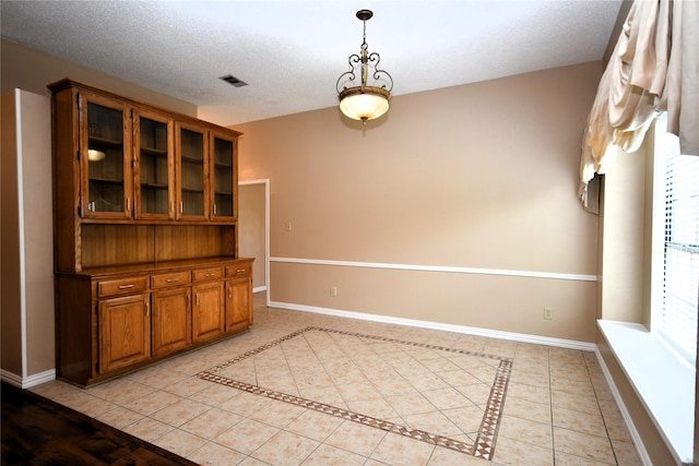 2906 Kingswood Dr, Garland, TX 75040 - unfurnished dining area featuring baseboards and light tile patterned flooring