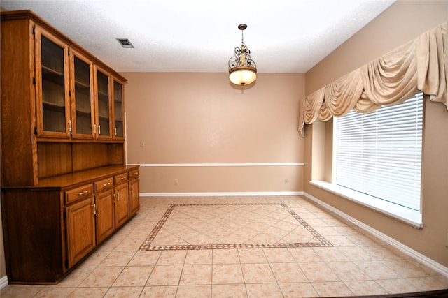 2906 Kingswood Dr, Garland, TX 75040 - unfurnished dining area featuring light tile patterned floors and baseboards