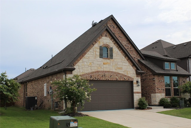 608 Remington Rd, Celina, TX 75009 - french country home featuring stone siding, concrete driveway, roof with shingles, and brick siding