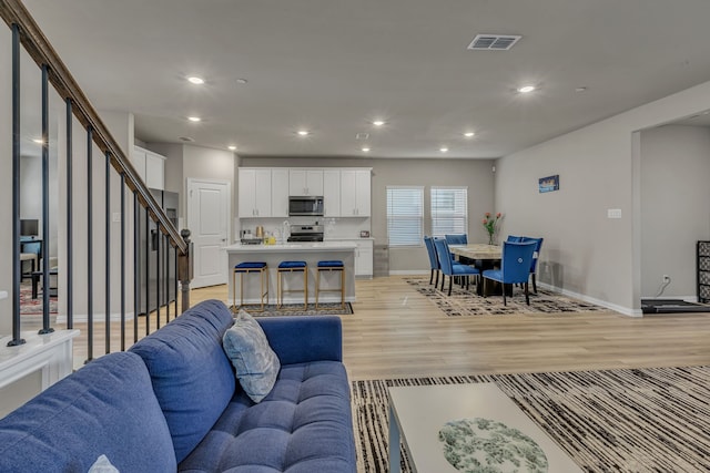 201 Olympus St, Wylie, TX 75098 - living area featuring stairway, baseboards, recessed lighting, and light wood-style floors
