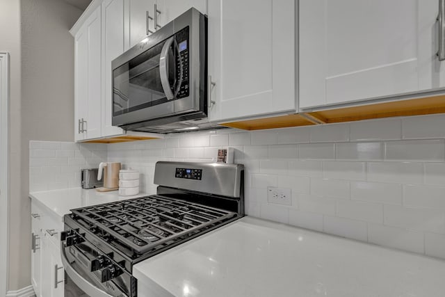201 Olympus St, Wylie, TX 75098 - kitchen featuring appliances with stainless steel finishes, light countertops, white cabinetry, and decorative backsplash