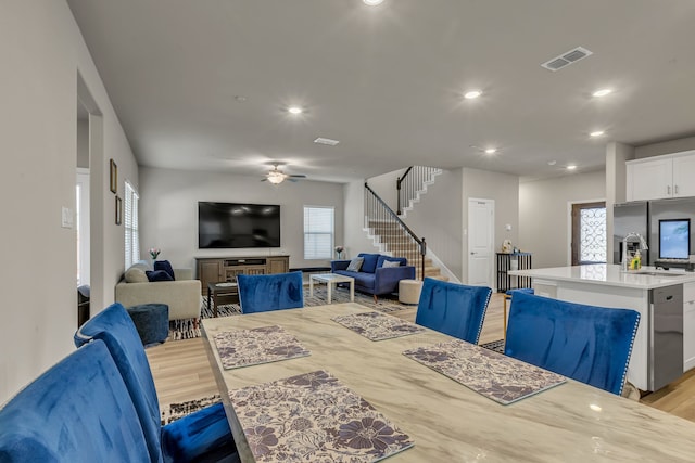 201 Olympus St, Wylie, TX 75098 - dining space featuring light wood finished floors, stairway, ceiling fan, and recessed lighting