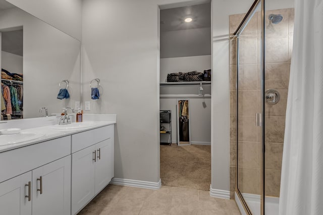 201 Olympus St, Wylie, TX 75098 - full bath with a spacious closet, double vanity, a stall shower, tile patterned flooring, and baseboards