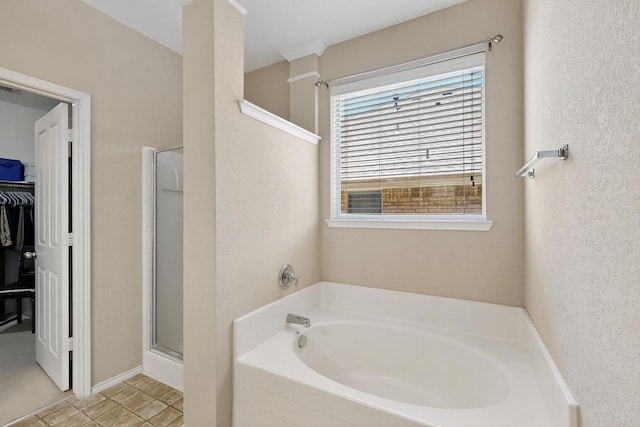 848 Ridge Point Dr, Grand Prairie, TX 75052 - bathroom with a garden tub, a spacious closet, and a shower stall