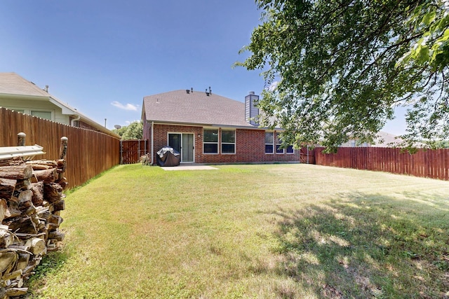 848 Ridge Point Dr, Grand Prairie, TX 75052 - rear view of property with brick siding, a fenced backyard, and a chimney