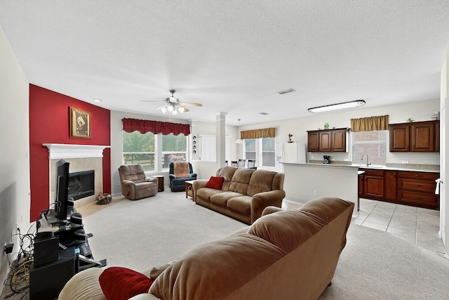 848 Ridge Point Dr, Grand Prairie, TX 75052 - living area with light colored carpet, a ceiling fan, a fireplace, and a textured ceiling