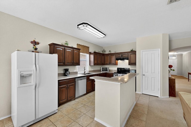 848 Ridge Point Dr, Grand Prairie, TX 75052 - kitchen featuring stainless steel appliances, ventilation hood, arched walkways, light countertops, and light tile patterned floors