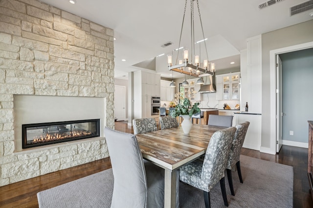 4003 Cheyenne Cir, Flower Mound, TX 75022 - dining room with dark wood-style floors, a fireplace, a chandelier, recessed lighting, and baseboards