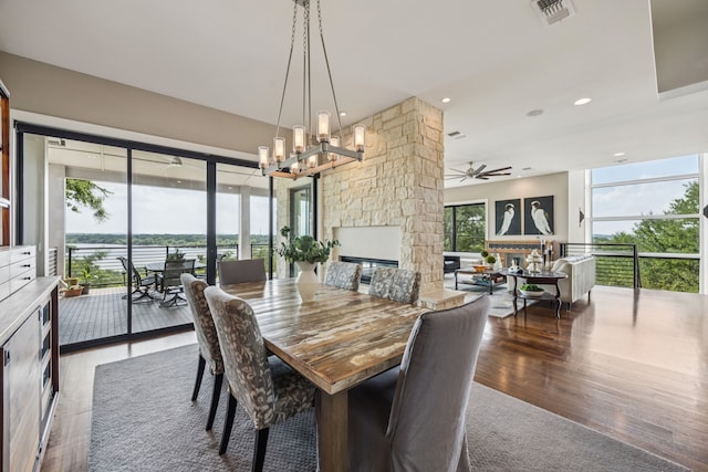 4003 Cheyenne Cir, Flower Mound, TX 75022 - dining room featuring a chandelier, wood finished floors, ceiling fan, a stone fireplace, and recessed lighting