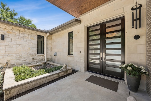 4003 Cheyenne Cir, Flower Mound, TX 75022 - property entrance with french doors, a garage, and stone siding