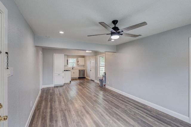 308 Chandler Dr, Garland, TX 75040 - unfurnished living room with a ceiling fan, wood finished floors, baseboards, recessed lighting, and a sink