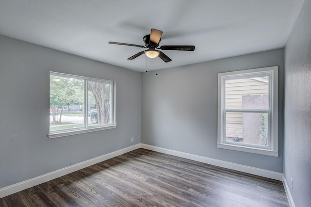 308 Chandler Dr, Garland, TX 75040 - empty room featuring dark wood-type flooring, baseboards, and a ceiling fan