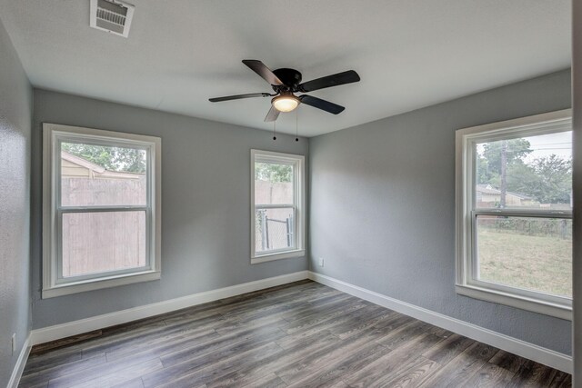 308 Chandler Dr, Garland, TX 75040 - empty room featuring dark wood-style flooring, baseboards, and ceiling fan