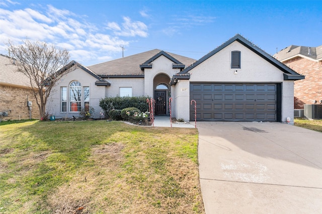 117 Baccus Dr, Mesquite, TX 75150 - view of front of property featuring brick siding, central AC unit, driveway, a front yard, and a garage