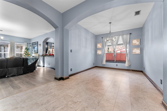117 Baccus Dr, Mesquite, TX 75150 - unfurnished dining area featuring plenty of natural light, arched walkways, a chandelier, and baseboards