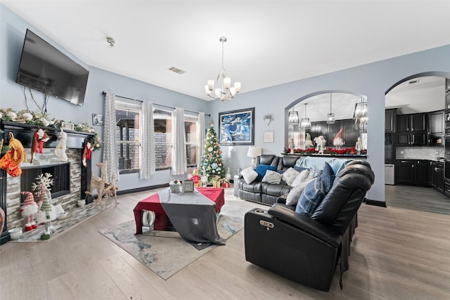 117 Baccus Dr, Mesquite, TX 75150 - living room with a chandelier, arched walkways, and light wood-style floors