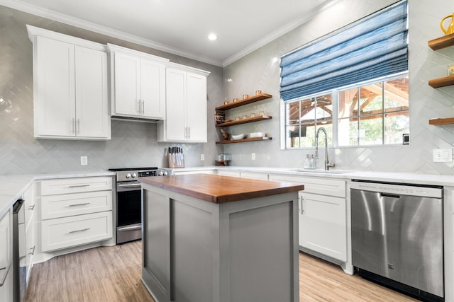 1310 Rolling Acres Dr, Argyle, TX 76226 - kitchen featuring stainless steel appliances, wooden counters, open shelves, a sink, and tasteful backsplash