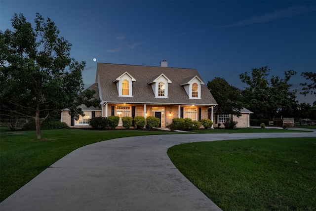 1310 Rolling Acres Dr, Argyle, TX 76226 - new england style home with a chimney, a front yard, brick siding, and curved driveway