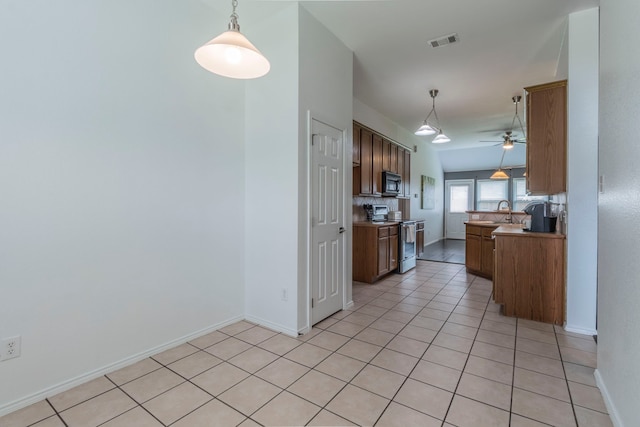2111 Preston Trl, Forney, TX 75126 - kitchen with stainless steel range with electric cooktop, black microwave, a ceiling fan, a sink, and light countertops