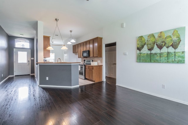 2111 Preston Trl, Forney, TX 75126 - kitchen featuring black microwave, stainless steel range with electric stovetop, wood finished floors, baseboards, and pendant lighting