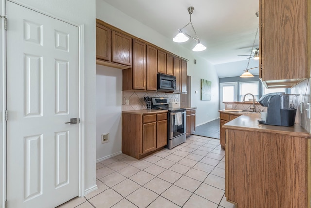 2111 Preston Trl, Forney, TX 75126 - kitchen with stainless steel electric range oven, black microwave, brown cabinets, and backsplash